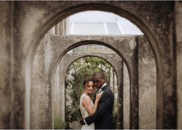 Bride and groom stand in the beautiful backdrop of Italy