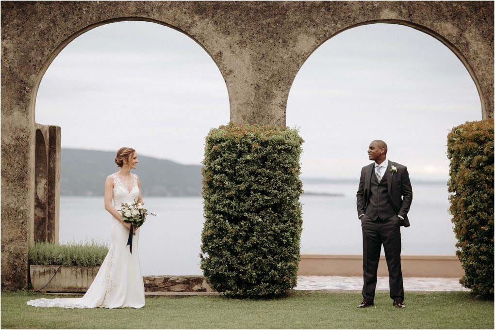 bride and groom pose in different archways, overlooking Garda Lake.