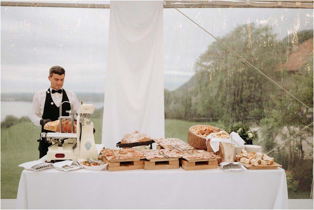 Outdoor wedding reception food under a tent.