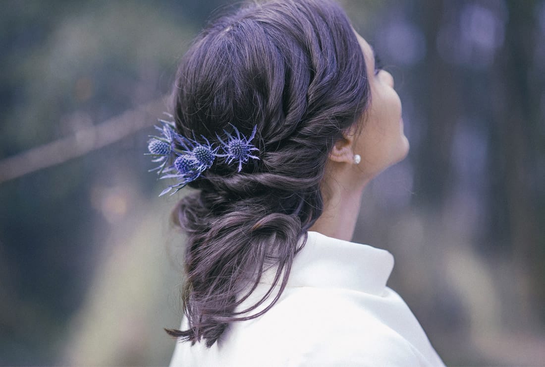 Blue thistle in a brides hair.