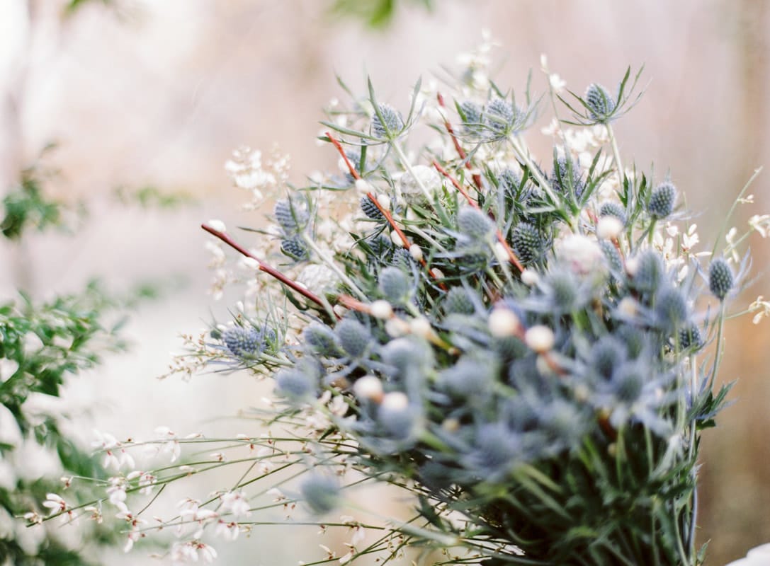 Winter bridal bouquet with soft blues and subtle greenery.