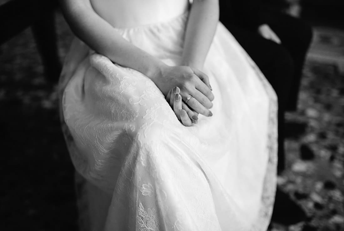 beautiful Italian bride sitting and waiting for her groom with folded hands.