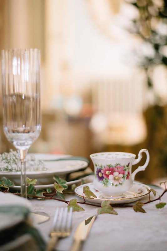 Small tea cup at an Italian wedding reception. A champagne flute sits next to it.