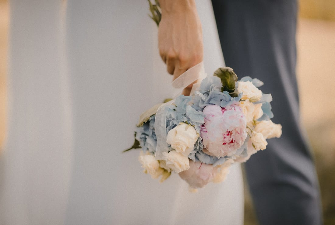 Small bridal bouquet of blue, cream and soft pink.