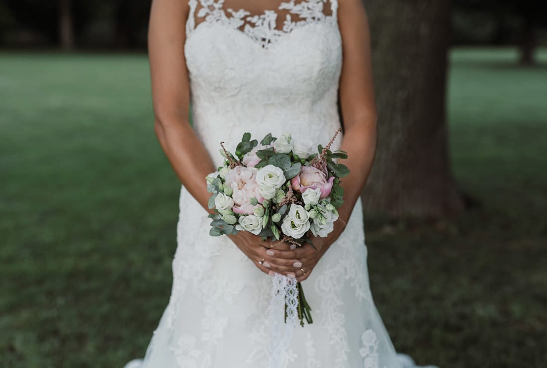 Italian bride with bouquet of eucalyptus, white and pink flowers.